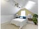Charming bedroom featuring sloped ceilings, fan, and two bedside tables with lamps at 2210 Douglas Rd, Indianapolis, IN 46220