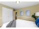 Cozy bedroom featuring neutral walls, white trim, and calming artwork above the bed at 2210 Douglas Rd, Indianapolis, IN 46220