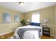 Bedroom with hardwood floors, lamps, and a comfortable bed at 2210 Douglas Rd, Indianapolis, IN 46220