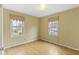 Bedroom with hardwood floors and two windows at 2210 Douglas Rd, Indianapolis, IN 46220