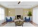Cozy living room featuring a fireplace and two armchairs at 2210 Douglas Rd, Indianapolis, IN 46220