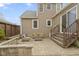 Outdoor patio area with a nice seating arrangement and stairs leading to the back door at 2210 Douglas Rd, Indianapolis, IN 46220