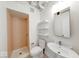 Clean bathroom features a stand-up shower, toilet, sink, mirror, and shelving at 230 E 9Th St # 502, Indianapolis, IN 46204