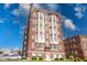 Classic brick apartment building with bright white window frames against a blue sky backdrop at 230 E 9Th St # 502, Indianapolis, IN 46204
