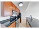 Efficient kitchen features granite counters, stainless appliances, and wood cabinetry at 230 E 9Th St # 502, Indianapolis, IN 46204