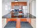Stylish kitchen with a granite-topped island, stainless steel appliances and bright cabinetry at 230 E 9Th St # 502, Indianapolis, IN 46204