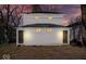 Back of property at twilight featuring new siding and a two-car garage at 241 N Tacoma Ave, Indianapolis, IN 46201
