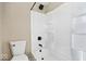 This renovated bathroom features a new white shower/tub, black hardware, and modern toilet at 241 N Tacoma Ave, Indianapolis, IN 46201