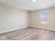 This bedroom features wood-look flooring, neutral walls, and natural light from the window at 241 N Tacoma Ave, Indianapolis, IN 46201