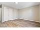 Bedroom showcasing spacious closet, neutral walls, and modern wood-look flooring at 241 N Tacoma Ave, Indianapolis, IN 46201