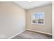 This bedroom features wood floors, neutral paint, and a window for natural light at 241 N Tacoma Ave, Indianapolis, IN 46201