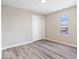 This bedroom features wood floors, a window for natural light, and a closet for storage at 241 N Tacoma Ave, Indianapolis, IN 46201