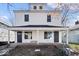 Charming two-story home featuring a covered front porch with white accents and black doors at 241 N Tacoma Ave, Indianapolis, IN 46201