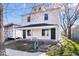 Charming two-story home featuring a covered front porch with white accents and black doors at 241 N Tacoma Ave, Indianapolis, IN 46201