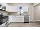 Modern kitchen features stainless steel appliances, granite countertops and white cabinets at 241 N Tacoma Ave, Indianapolis, IN 46201