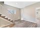Open-concept living room with stairs, modern floors and a window for natural light at 241 N Tacoma Ave, Indianapolis, IN 46201