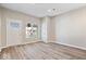 Bright living room with modern floors and a large front door window for natural light at 241 N Tacoma Ave, Indianapolis, IN 46201