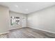 Bright, open living room features modern gray floors, white trim and door, fresh paint and natural light at 241 N Tacoma Ave, Indianapolis, IN 46201