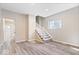 Open-concept living room with stairs, modern floors and a window for natural light at 241 N Tacoma Ave, Indianapolis, IN 46201