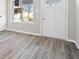 Living room boasts modern gray flooring, large window and freshly painted walls at 241 N Tacoma Ave, Indianapolis, IN 46201