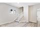 Inviting living room featuring contemporary flooring and a staircase with white rails at 241 N Tacoma Ave, Indianapolis, IN 46201