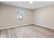 Newly renovated bedroom with light gray wood floors and fresh paint at 243 N Tacoma Ave, Indianapolis, IN 46201