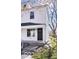 Charming two-story home featuring a black front door, white siding, and a welcoming front porch at 243 N Tacoma Ave, Indianapolis, IN 46201