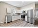 Modern kitchen featuring stainless steel appliances, granite countertops, and sleek white cabinets at 243 N Tacoma Ave, Indianapolis, IN 46201