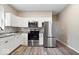 Modern kitchen featuring stainless steel appliances, granite countertops, and sleek white cabinets at 243 N Tacoma Ave, Indianapolis, IN 46201