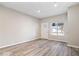 An inviting living room with luxury vinyl plank flooring and a front door to welcome guests at 243 N Tacoma Ave, Indianapolis, IN 46201
