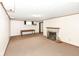 Finished basement features a fireplace, storage, and neutral carpeted floors, ideal for a Gathering room at 25 W 59Th St, Indianapolis, IN 46208