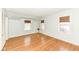 Sunny bedroom featuring wood floors and multiple windows with wooden blinds at 25 W 59Th St, Indianapolis, IN 46208