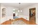 Elegant dining room with hardwood floors, chandelier, and access to the kitchen and living areas at 25 W 59Th St, Indianapolis, IN 46208
