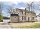 View of the home showing its stone and siding exterior, and a detached garage at 25 W 59Th St, Indianapolis, IN 46208