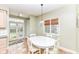View of the eat-in kitchen, featuring glass paneled doors to the backyard and seating for four at 25 W 59Th St, Indianapolis, IN 46208