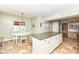 Eat-in kitchen with white table and chairs next to a large island with countertop seating at 25 W 59Th St, Indianapolis, IN 46208