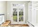 Sun room features a bench seat, coat hooks and glass panel doors to the backyard at 25 W 59Th St, Indianapolis, IN 46208