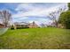 Well-maintained back yard offers a relaxing view of the property and blue skies above the neighborhood at 2511 Ritter Dr, Anderson, IN 46012