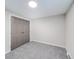 Bedroom featuring modern gray floors, new paint, and ample closet space at 2511 Ritter Dr, Anderson, IN 46012