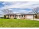 Charming single-story home with a well-manicured lawn and an attached two-car garage at 2511 Ritter Dr, Anderson, IN 46012