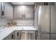 Kitchen with stainless steel appliances, gray cabinets, and marble countertop at 2511 Ritter Dr, Anderson, IN 46012