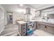 Bright kitchen boasts stainless appliances, gray cabinets, breakfast nook and modern flooring at 2511 Ritter Dr, Anderson, IN 46012