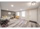 Open living room with wood floors, a gray sofa, and bright natural light at 2511 Ritter Dr, Anderson, IN 46012
