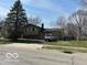 Charming two-story home with a large front yard and attached two-car garage at 2526 Sheffield Dr, Indianapolis, IN 46229