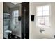 Bathroom featuring a tiled shower, toilet, shelves, and a window at 253 1St Nw St, Carmel, IN 46032