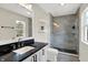Bright bathroom featuring a shower, toilet, double sinks, and floating shelves at 253 1St Nw St, Carmel, IN 46032