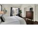 Comfortable bedroom featuring a chair, dresser and ample sunlight at 253 1St Nw St, Carmel, IN 46032