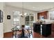 Bright dining area with patio access, featuring a stylish chandelier and modern fixtures at 253 1St Nw St, Carmel, IN 46032