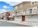 Exterior shot showcasing a well-maintained townhome with attached garages and balconies at 253 1St Nw St, Carmel, IN 46032