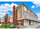 View of townhomes featuring attached garages, balconies, brick accents, and neutral siding at 253 1St Nw St, Carmel, IN 46032